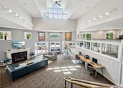 Thumbnail 19 of 43 - A spacious room with a fireplace, couches, and a ceiling fan. at University Ridge Apartments, North Carolina, 27707