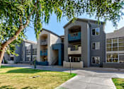 Thumbnail 70 of 105 - A modern apartment building with a tree in the foreground at Sweetwater At Metro North Apartments, Phoenix  85029