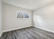 Thumbnail 26 of 45 - A room with a window and a grey floor at Spyglass Creek, Denver, 80224