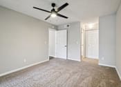 Thumbnail 11 of 55 - A room with a ceiling fan and carpeted floor. at Lakeside Glen Apartments, Florida, 32904