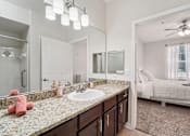 Thumbnail 18 of 44 - A bathroom with a sink, mirror, and bed.at Kingwood Glen, Kingwood, 77339