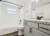 Thumbnail 16 of 55 - A white toilet sits in a bathroom with a marble counter. at Lakeside Glen Apartments, Melbourne, FL, 32904