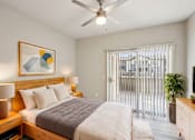 Thumbnail 1 of 105 - A bedroom with a bed, nightstand, and a painting on the wall at Sweetwater At Metro North Apartments, Arizona