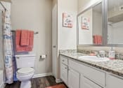 Thumbnail 19 of 51 - a bathroom with a sink and a toilet and a mirror at The Glen at Highpoint, Dallas, 75243