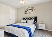 Thumbnail 16 of 51 - a bedroom with a bed and a ceiling fan at The Glen at Highpoint, Dallas, 75243
