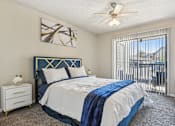 Thumbnail 15 of 51 - a bedroom with a bed and a ceiling fan at The Glen at Highpoint, Dallas, 75243