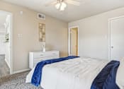 Thumbnail 17 of 51 - a bedroom with a bed and a ceiling fan at The Glen at Highpoint, Dallas, 75243