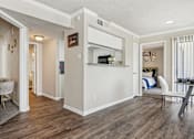 Thumbnail 4 of 51 - the living room and kitchen of a home with a hard wood floor at The Glen at Highpoint, Dallas, 75243