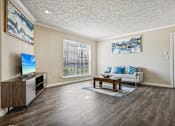 Thumbnail 2 of 51 - a living room with a couch and a table and a tv at The Glen at Highpoint, Dallas, 75243