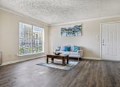 Thumbnail 3 of 51 - the living room of an apartment with a couch and a coffee table at The Glen at Highpoint, Dallas, 75243