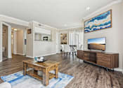 Thumbnail 1 of 51 - a living room with a table and a television at The Glen at Highpoint, Dallas, 75243