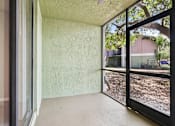 Thumbnail 17 of 55 - A room with a sliding glass door leading to a backyard. at Lakeside Glen Apartments, Melbourne, FL
