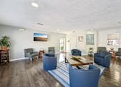 Thumbnail 15 of 35 - A living room with a blue couch and a wooden coffee table. at Sarasota South Apartments, Bradenton, FL, 34207