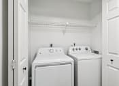 Thumbnail 10 of 55 - A small laundry room with a washer and dryer. at Lakeside Glen Apartments, Melbourne, Florida