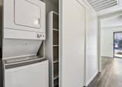 Thumbnail 26 of 47 - A white dishwasher and oven in a kitchen at Del Coronado Apartment , Mesa