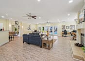 Thumbnail 19 of 32 - A spacious living room with a ceiling fan and a couch. at Cedar Springs Apartments, North Carolina