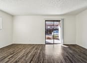 Thumbnail 31 of 47 - A room with a sliding glass door leading to a street at Del Coronado Apartment , Mesa