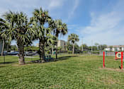Thumbnail 35 of 35 - A park with a red pole and a green bench. at Sarasota South Apartments, Bradenton, 34207