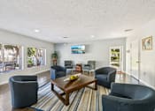 Thumbnail 19 of 35 - A living room with a large couch, a chair, and a coffee table. at Sarasota South Apartments, Florida