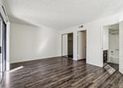 Thumbnail 28 of 47 - A room with wooden floors and white walls at Del Coronado Apartment , Arizona