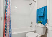 Thumbnail 25 of 51 - a bathroom with a shower curtain and a toilet at The Glen at Highpoint, Dallas, 75243