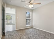 Thumbnail 30 of 51 - an empty living room with a ceiling fan and a window at The Glen at Highpoint, Dallas, 75243
