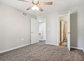 Thumbnail 35 of 51 - a living room with carpet and a ceiling fan at The Glen at Highpoint, Dallas, 75243