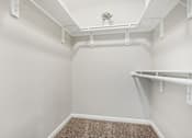 Thumbnail 36 of 51 - a spacious walk in closet in a home with white walls and a roll in shower at The Glen at Highpoint, Dallas, 75243