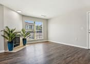 Thumbnail 38 of 51 - an empty living room with a window and a door at The Glen at Highpoint, Dallas, 75243