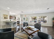 Thumbnail 18 of 35 - A living room with a brown table and grey chairs. at Sarasota South Apartments, Florida, 34207