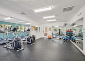 Thumbnail 26 of 32 - A gym with treadmills, exercise balls, and weights. at Cedar Springs Apartments, North Carolina, 27609