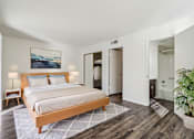 Thumbnail 32 of 47 - A bedroom with a large bed and a painting on the wall at Del Coronado Apartment , Mesa, 85202