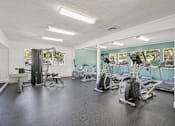Thumbnail 27 of 32 - A gym with a variety of equipment including treadmills, stationary bikes, and weight machines. at Cedar Springs Apartments, North Carolina, 27609