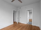 Thumbnail 14 of 34 - A room with white walls and wooden floors with a ceiling fan.at The Collection of Historic Richmond, Richmond, 23220