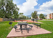 Thumbnail 27 of 35 - A picnic table and chairs are set up on a patio. at Broadmoor Springs, Colorado Springs