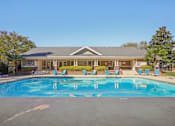 Thumbnail 32 of 32 - A large swimming pool in front of a building with a blue sky in the background. at Cedar Springs Apartments, Raleigh, 27609
