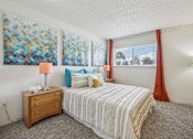 Thumbnail 8 of 45 - A bedroom with a bed, nightstand, and two wall art pieces at Spyglass Creek, Denver, 80224