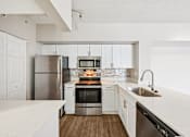 Thumbnail 54 of 117 - A modern kitchen with stainless steel appliances and white cabinetry. at Heritage Bay, Florida
