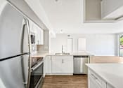 Thumbnail 53 of 117 - A modern kitchen with white cabinets and a large refrigerator. at Heritage Bay, Florida, 34957