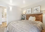 Thumbnail 17 of 62 - A bedroom with a large bed and two pictures on the wall. at Cliffs at Canyon Ridge, Utah, 84401