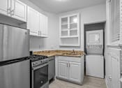 Thumbnail 9 of 34 - A kitchen with a stove, oven, and refrigerator.at The Collection of Historic Richmond, Richmond
