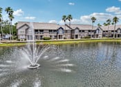 Thumbnail 20 of 31 - A fountain in the foreground of a building complex at The Parkway at Hunters Creek, Orlando, 32837