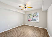 Thumbnail 61 of 117 - A room with a ceiling fan and a window with blinds. at Heritage Bay, Jensen Beach