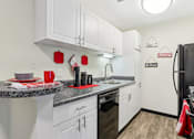 Thumbnail 33 of 57 - A kitchen with white cabinets and a black refrigerator. at Millennium at Creve Coeur, Creve Coeur, 63141