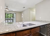 Thumbnail 47 of 58 - A kitchen with granite countertops and stainless steel appliances. at Canopy Glen, Georgia, 30093
