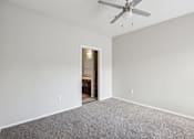 Thumbnail 66 of 105 - A room with a ceiling fan and carpeted floor at Sweetwater At Metro North Apartments, Arizona