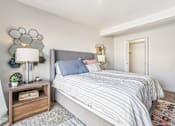 Thumbnail 20 of 62 - A bedroom with a bed, nightstand, and lamp. at Cliffs at Canyon Ridge, Utah, 84401