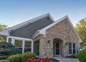 Thumbnail 13 of 20 - an exterior view of a stone building with a driveway and trees at Brookstone Village, Cincinnati