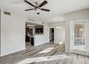 Thumbnail 24 of 105 - A room with a ceiling fan and wooden flooring at Sweetwater At Metro North Apartments, Phoenix