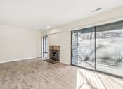 Thumbnail 33 of 62 - A large, empty room with a fireplace and a view of a snowy landscape outside. at Cliffs at Canyon Ridge, Utah, 84401